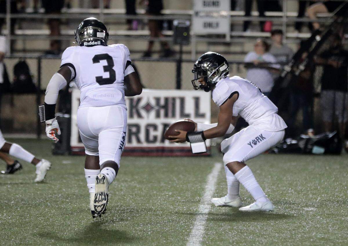 York’s Aiden Davis prepares to hand the ball off to Frank Thompson.