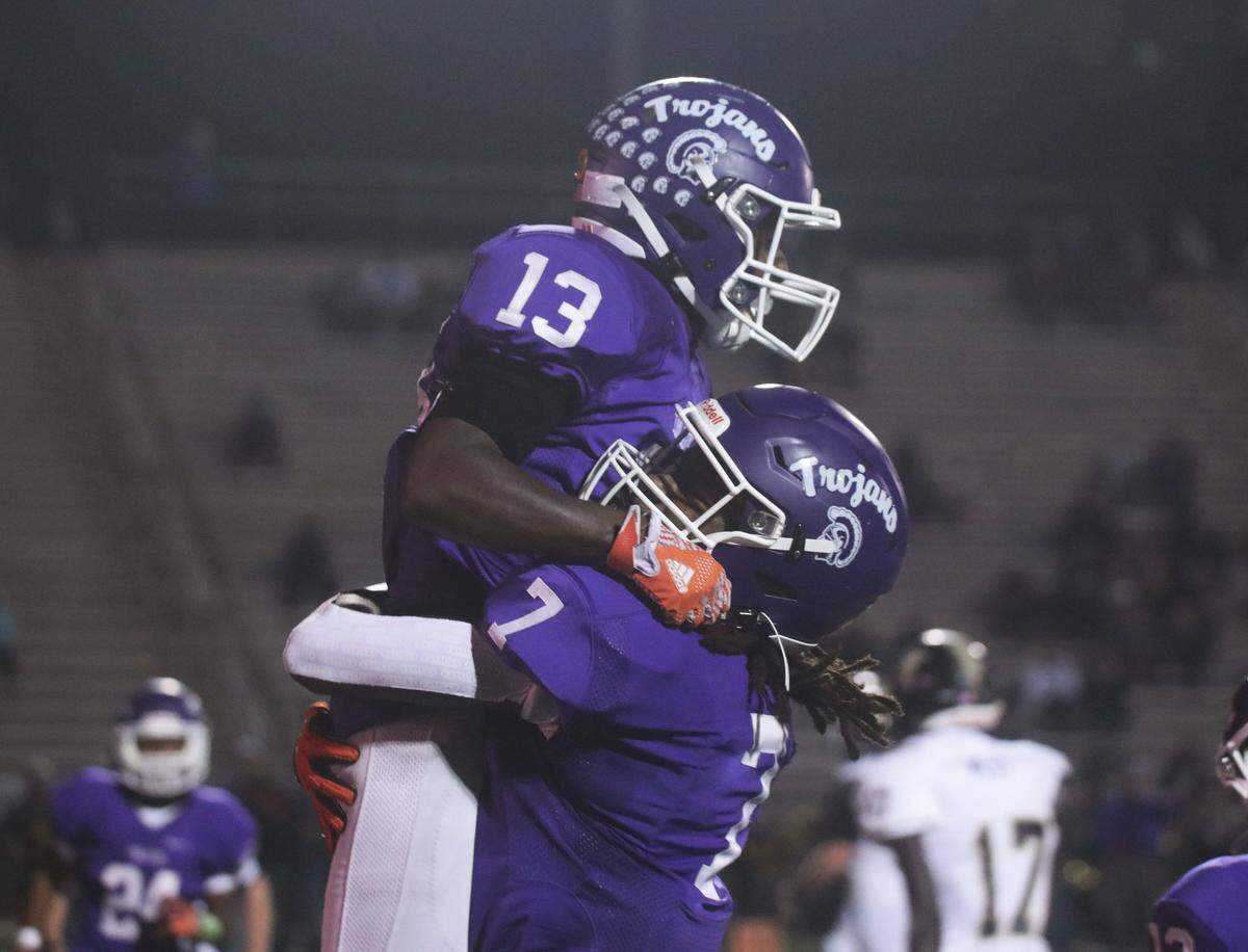 Northwestern’s Gerell Watkins, left, and Elijah Caldwell celebrate after Watkins scores a touchdown Friday. The Trojans fell to the T.L. Hanna Yellow Jackets in the SC semi-finals in Rock Hill.