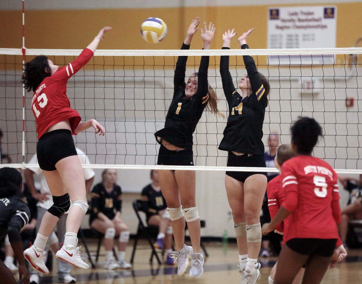 Northwestern’s Darby Grigg (7) and Hayes Nunn (14) hit the ball against South Pointe’s Victoria Petrovich.