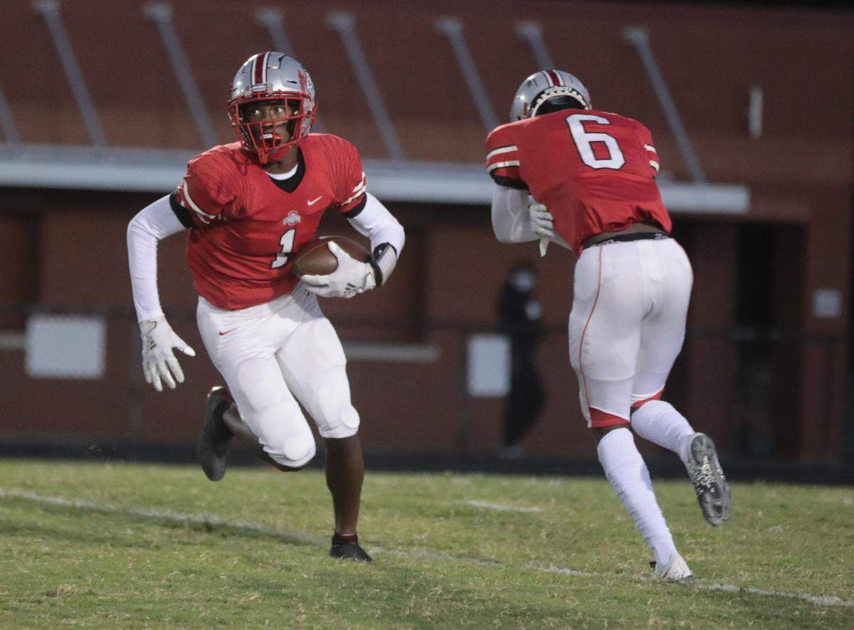 South Pointe wide receiver Waymond Jenerette carries the ball past Quan Peterson.
