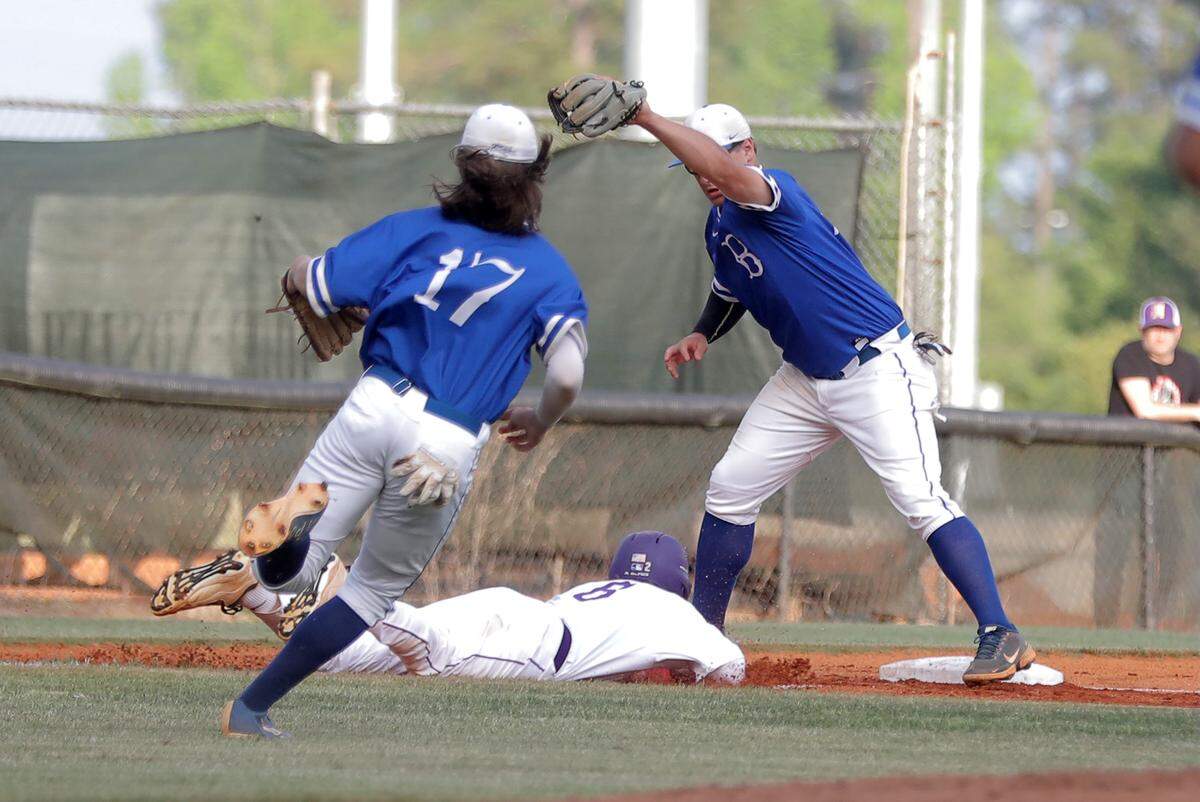 Northwestern’s C.J. Smalley slides back into third base Thursday in Rock Hill.