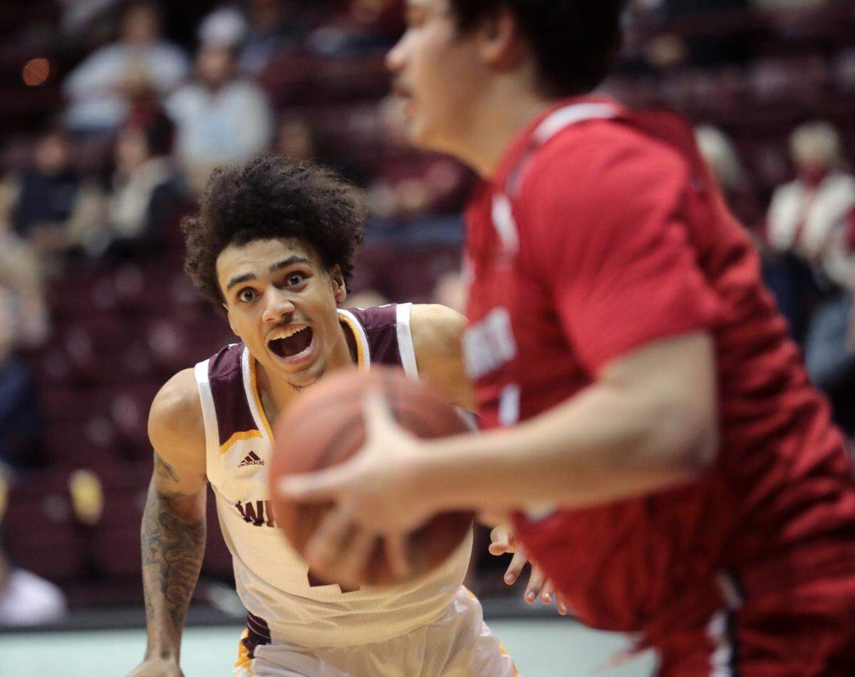 Winthrop’s Kelton Talford watches the ball as Hartford’s David Shriver looks for an opening.