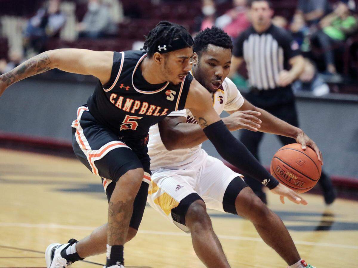 Winthrop’s Russell Jones, Jr. dribbles around Campbell’s Messiah Thompson.