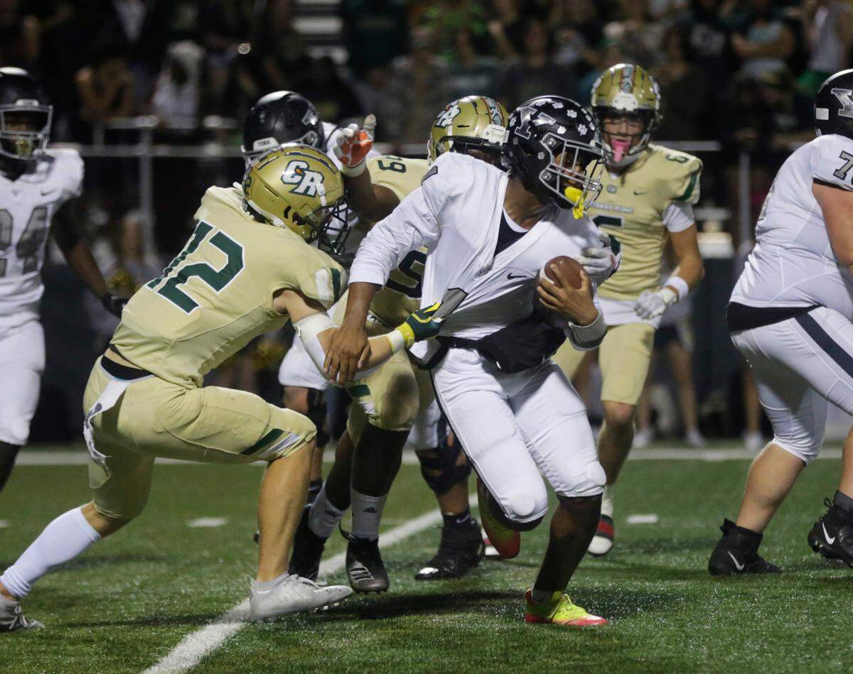 Catawba Ridge’s Evan Hamilton (12) tries to stop York’s Ayden Davis Friday, Oct. 7, 2022 as the Copperheads and Cougars compete in Fort Mill.
