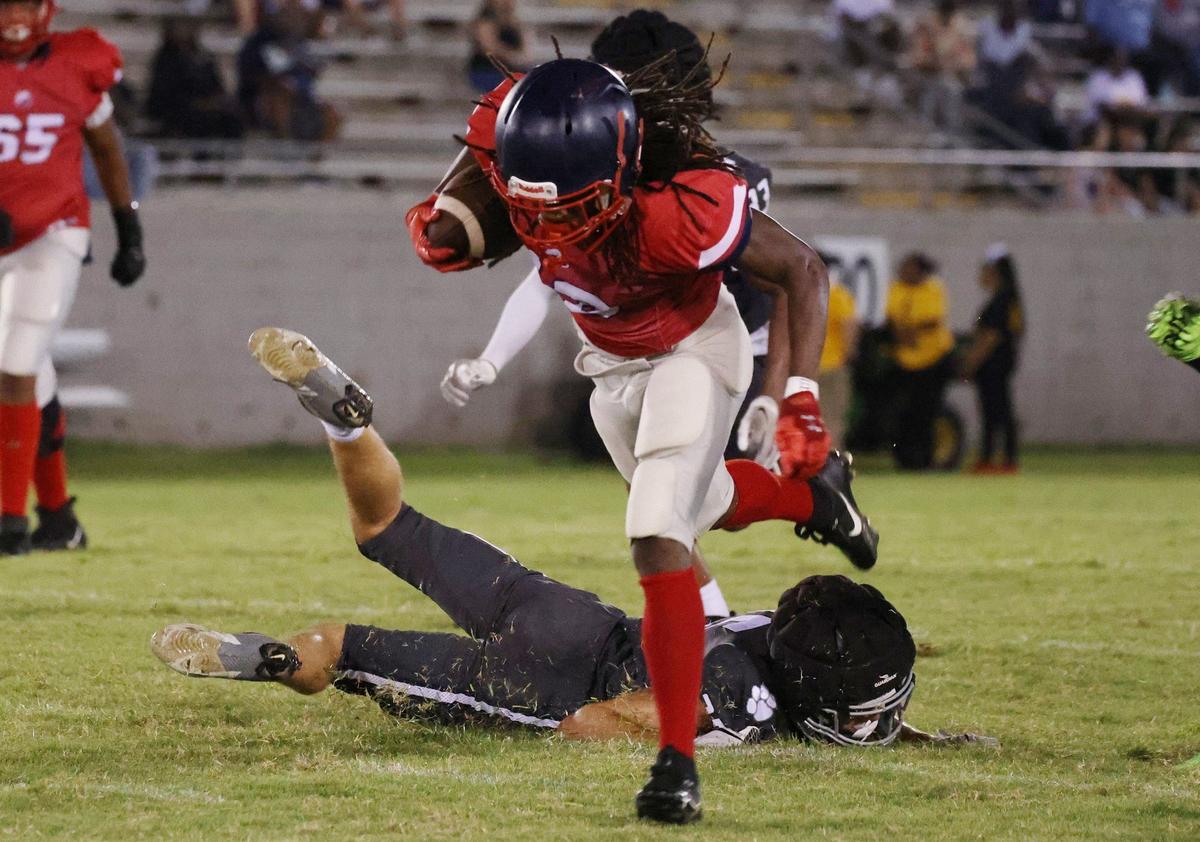 York’s Bennett Reeder falls on the grorund as Chester’s T’Mari Caldwell runs with the ball Friday at a scrimmage.