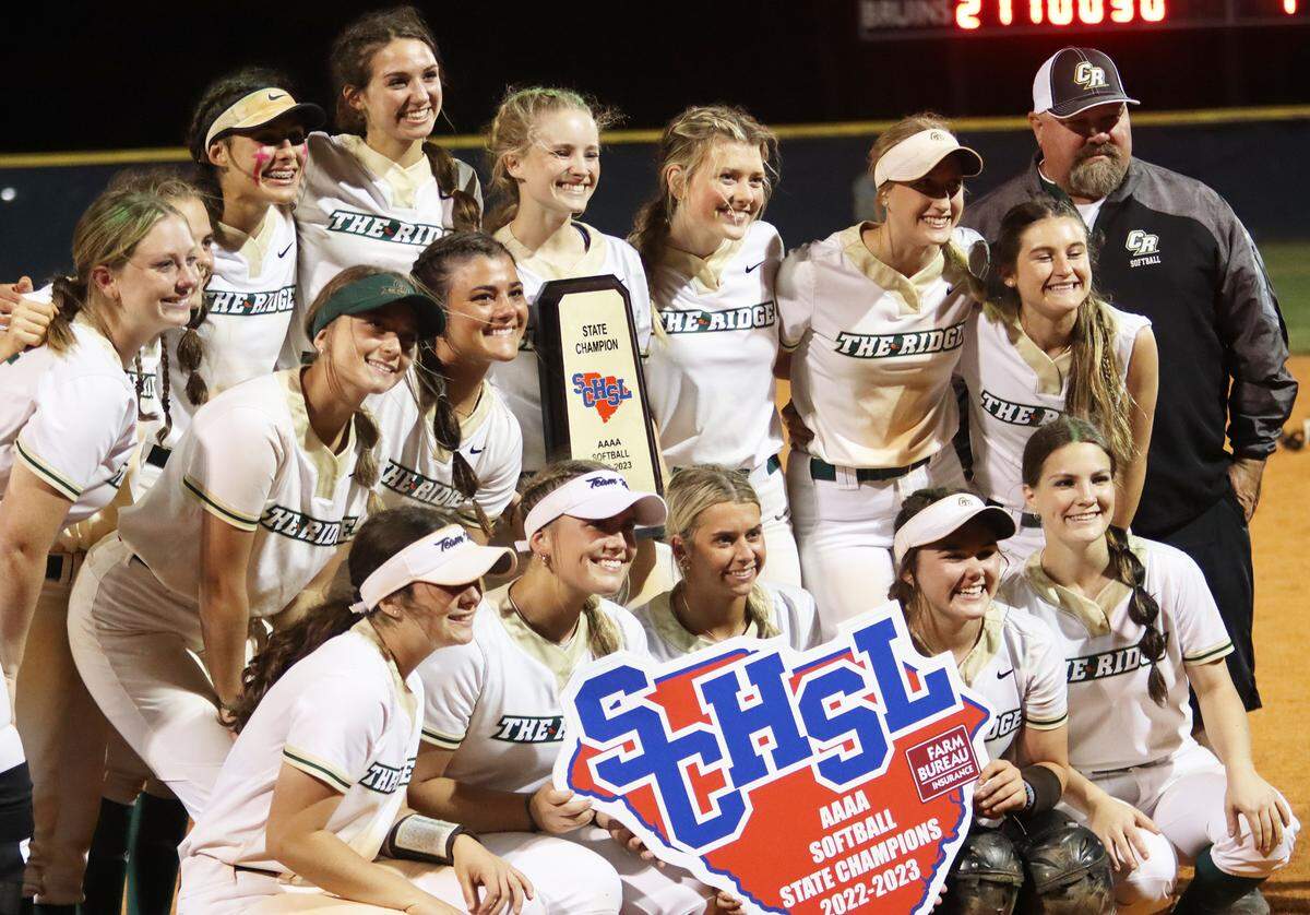 The Catawba Ridge softball team poses for a picture following their title-clinching 10-7 win over South Florence. Head coach Michael Kidd (black, grey sweatshirt; far right) said that the moment means a lot after seeing his players grow from seventh- and eighth-graders to state champions