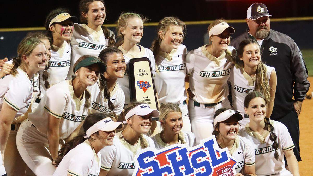 The Catawba Ridge softball team poses for a picture following their title-clinching 10-7 win over South Florence. Head coach Michael Kidd (black, grey sweatshirt; far right) said that the moment means a lot after seeing his players grow from seventh- and eighth-graders to state champions
