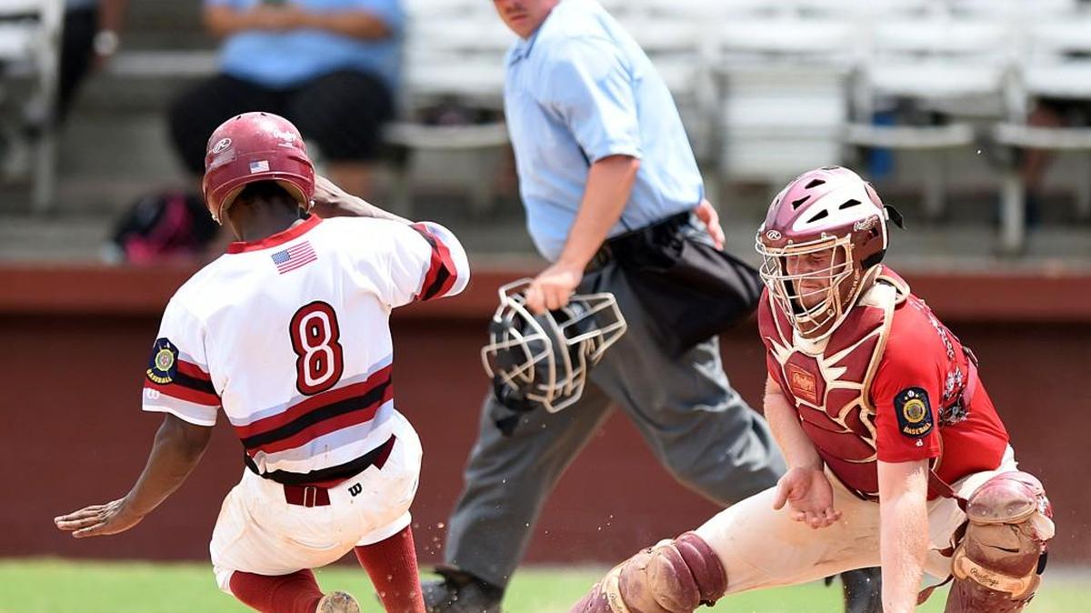 RICK CAREPNTER/THE SUMTER ITEM Florence's Zay Paul (8) scored on two throws to Rock Hill catcher Brandon Banks Wednesday in the finals of the America Legion state tournament at Riley Park in Sumter. Florence won two games on Wednesday, including the finale, 4-0.