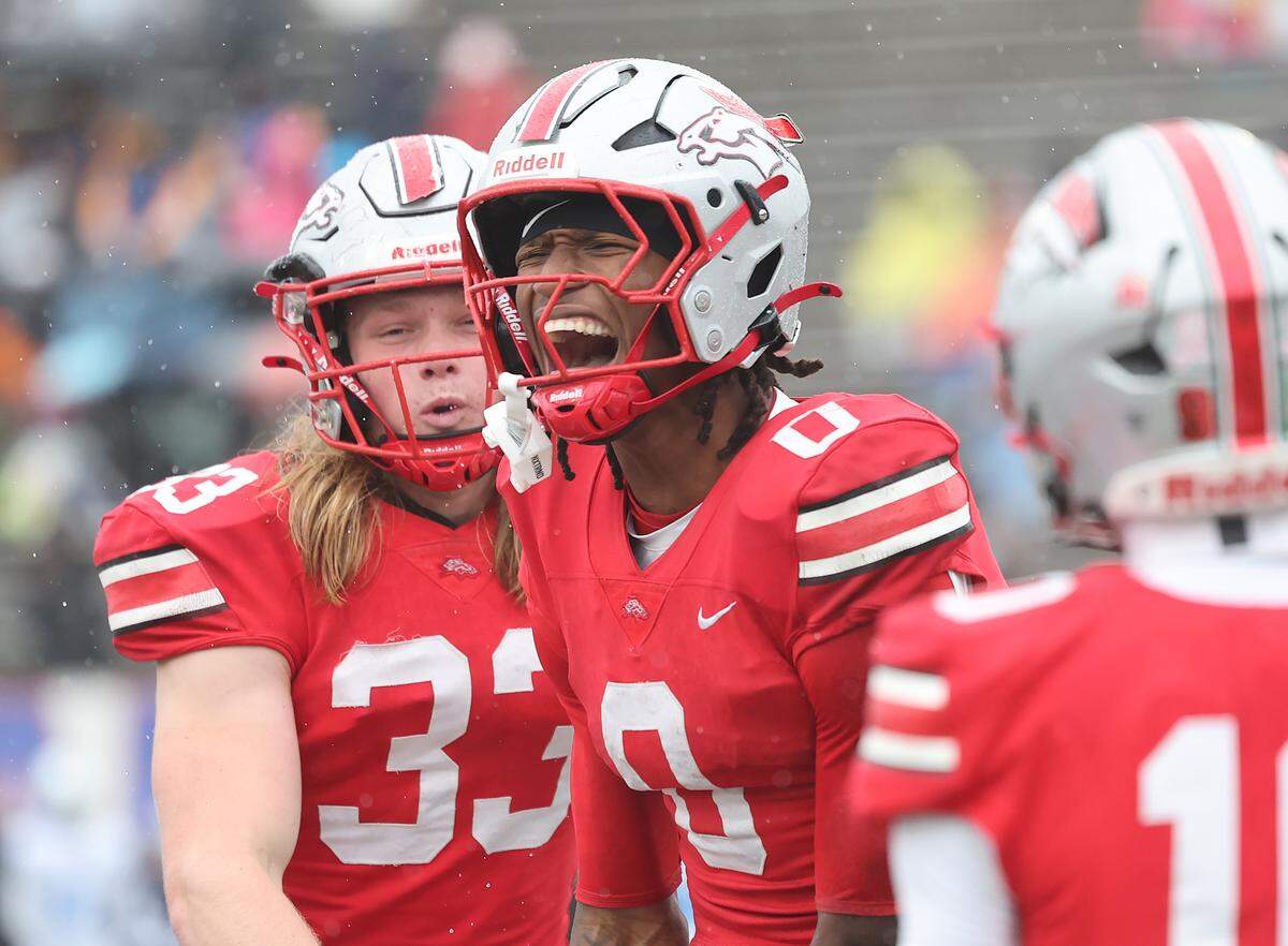 South Pointe's J'zavien Currence (0) and Brysen Ginn celebrate after scoring Saturday at the SC High School League Class 4A football championship