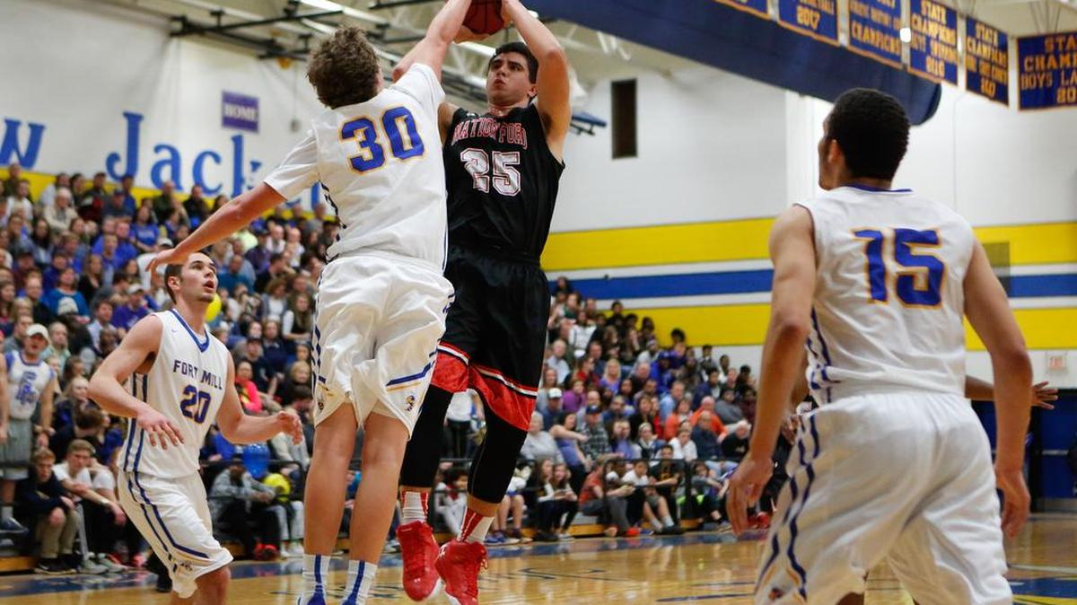 Fort Mill’s Rogan Wells (30) blocks a shot by Nation Ford’s Hank Tuipulotu on Friday.