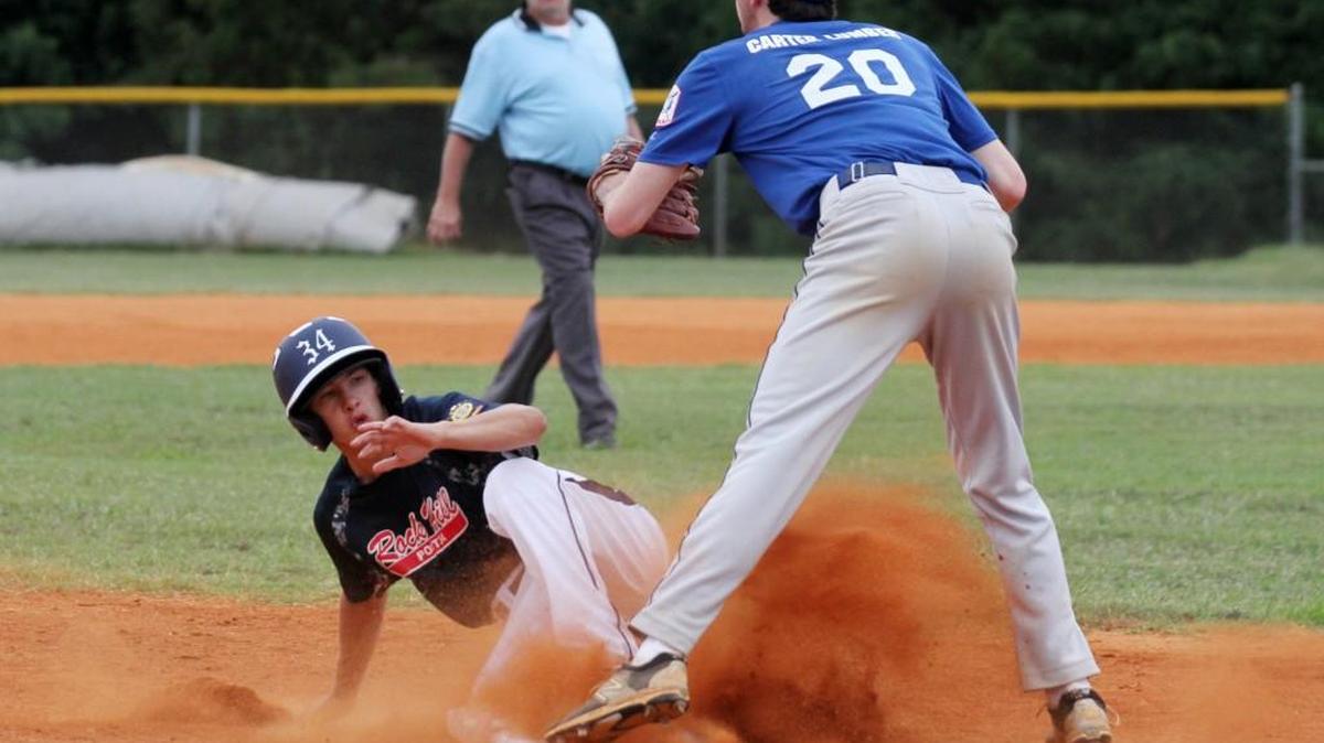 Rock Hill baserunner Andrew Shipman slides into third base as Fort Mill’s Josh Jones waits for the throw Tuesday during an American Legion doubleheader at Fort Mill High School.