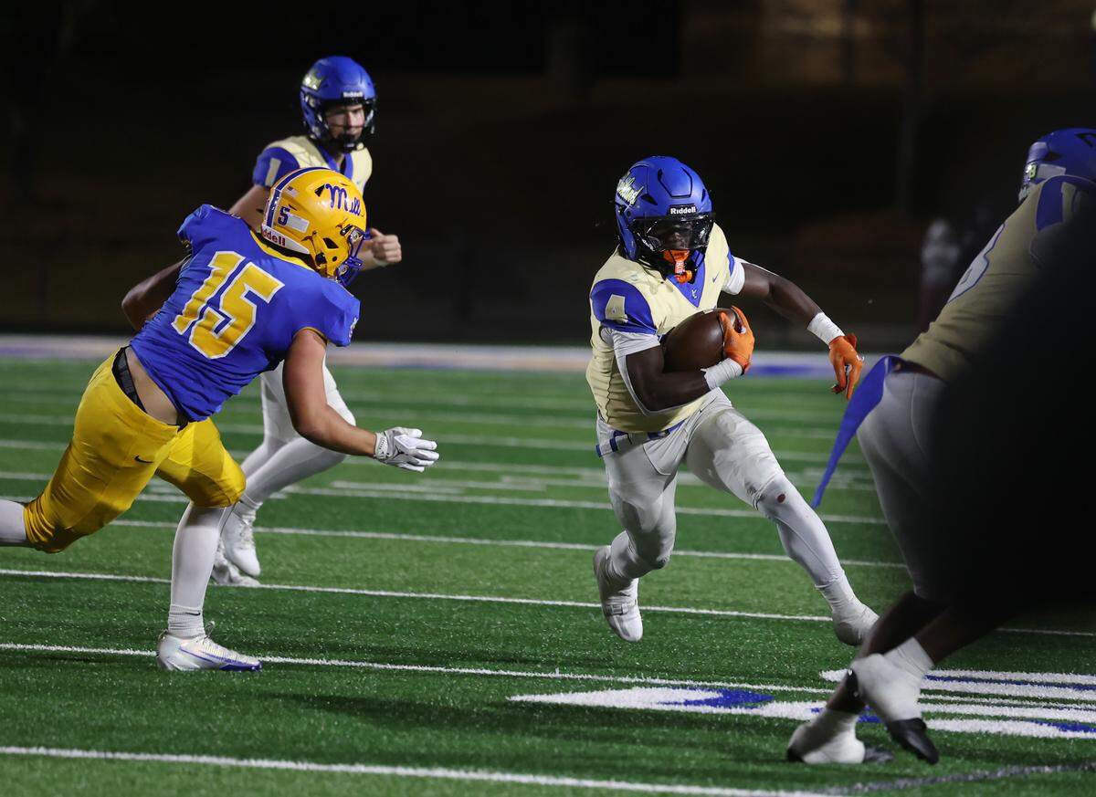 Indian Land's Jamol Horton carries the ball against Fort Mill's Andrew Kowalski (15) on Friday in Fort Mill. 