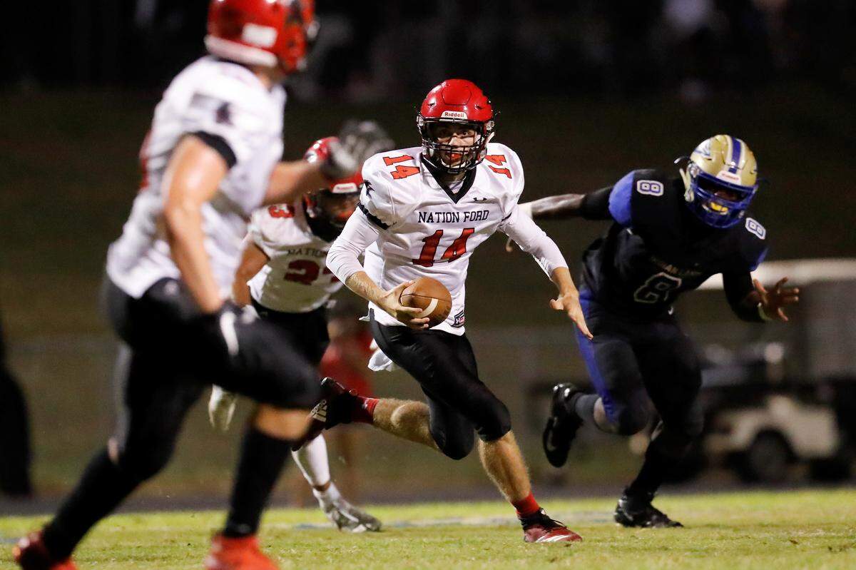 Nation Ford quarterback #14 Gabe Huitt carries the ball against Indian Land.