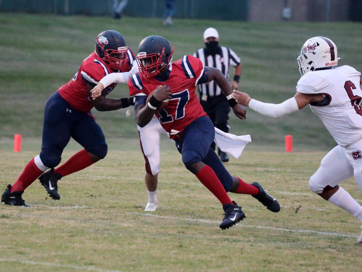Zan Dunham carries the ball Friday as the Chester Cyclones take on the Mid-Carolina Rebels in Chester.