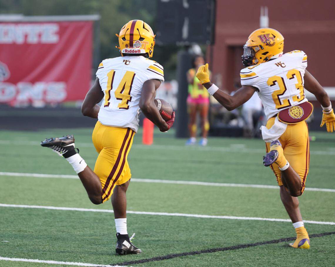 West Charlotte's Davion Jones heads to the end zone alongside Sincere Gray in the first play of the game against South Pointe Friday, Sept. 5, 2025 in Rock Hill.