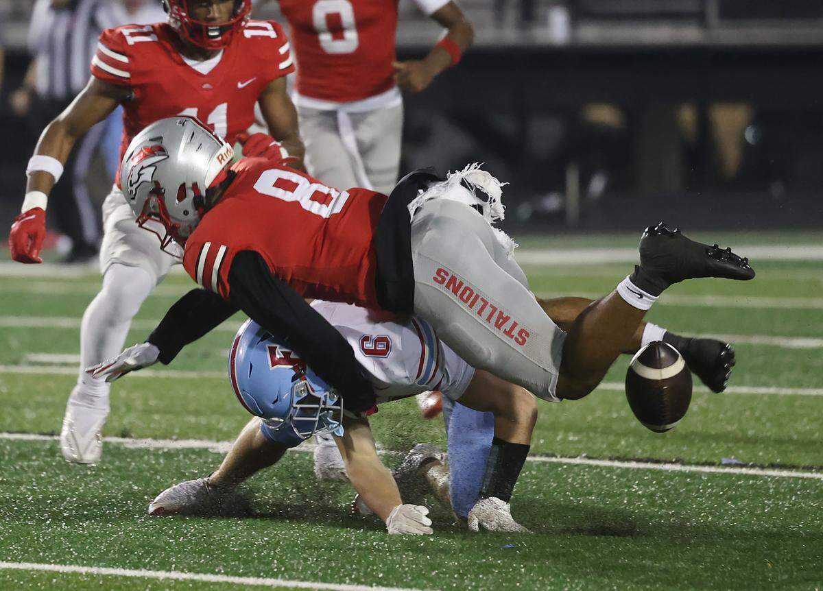 South Pointe's Kadin Watkins (8) knocks the ball away from A.C. Flora's Blake Betette on Friday, Nov.21, 2025 in Rock Hill, S.C.