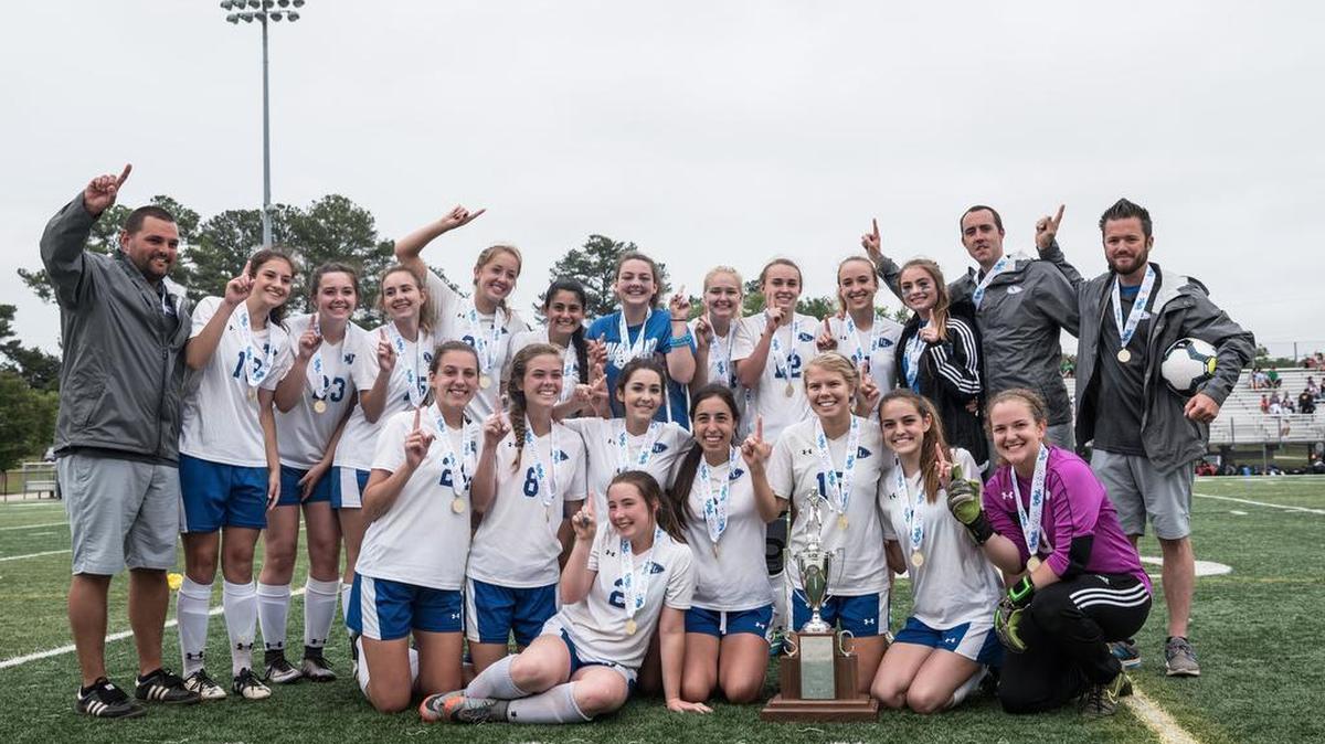 Indian Land players and coaches pose with their newly acquired Class 3A Girl's Soccer State Championship trophy.