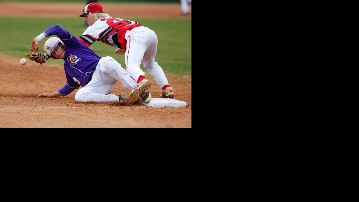 
Northwestern's No. 3 Weston King slides safe into third base before the ball gets to South Pointe’s Stephen Thompson as Northwestern hosts the Stallions in high school baseball, 4-9-2015. The Stallions beat Northwestern 8-5, their first win over the Trojans in school history.
