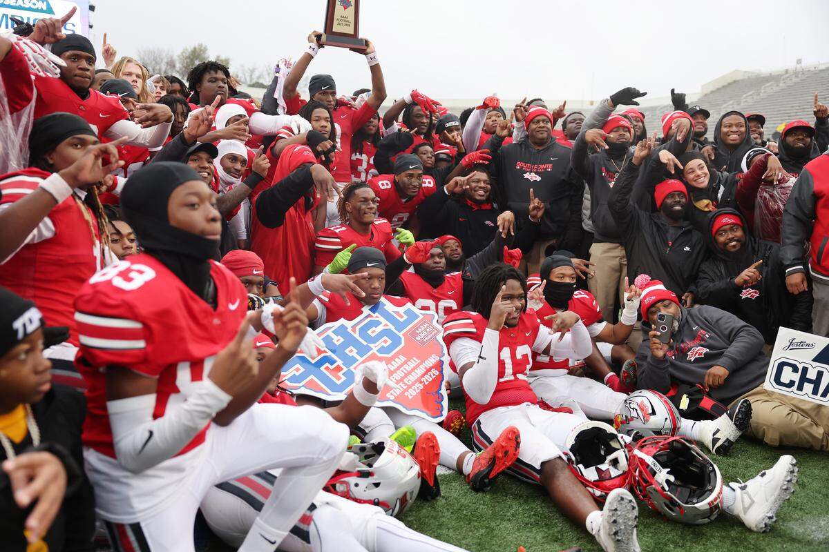 The South Pointe High School Stallions celebrate with a photo after winning the SC High School League Class 4A football championship in Orangeburg, S.C.