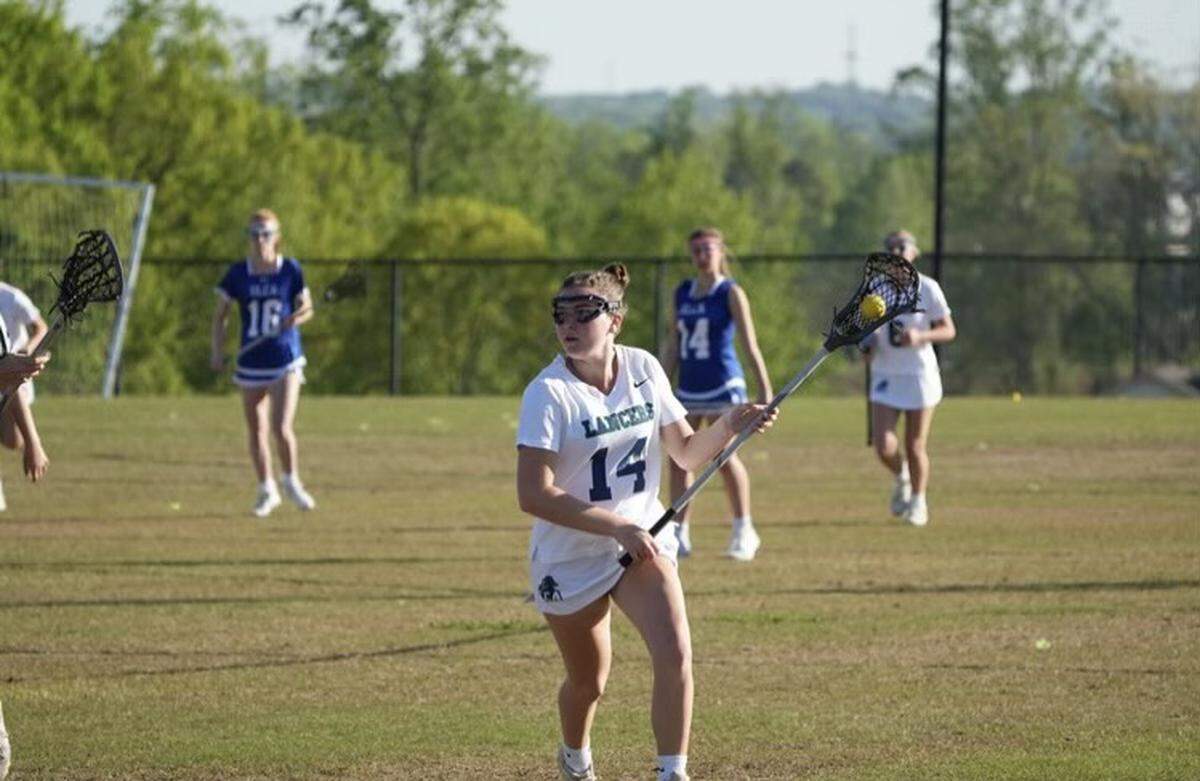 Morgan Savage (white, 14) had 13 points this season with eight goals and five assists.
