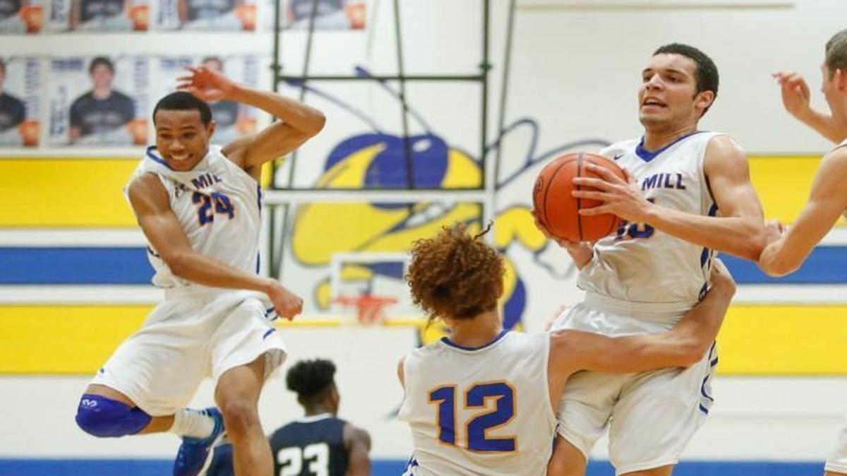 Fort Mill’s basketball team celebrates a win over Spartanburg that sends the Yellow Jackets to the third round of the 4A playoffs.