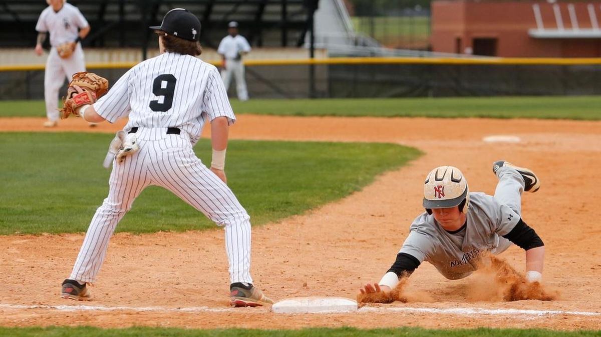 Nation Ford’s Jordan Helms makes it back to first base as Nation Ford battles South Pointe in the Wheels Baseball Invitational Wednesday.