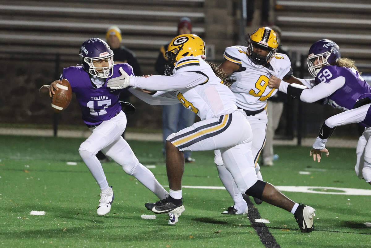 Northwestern’s Xavier Means (17) tries to push off Greenwood’s Nehemiah Cook Friday as the Trojans and Eagles face off in the playoffs.