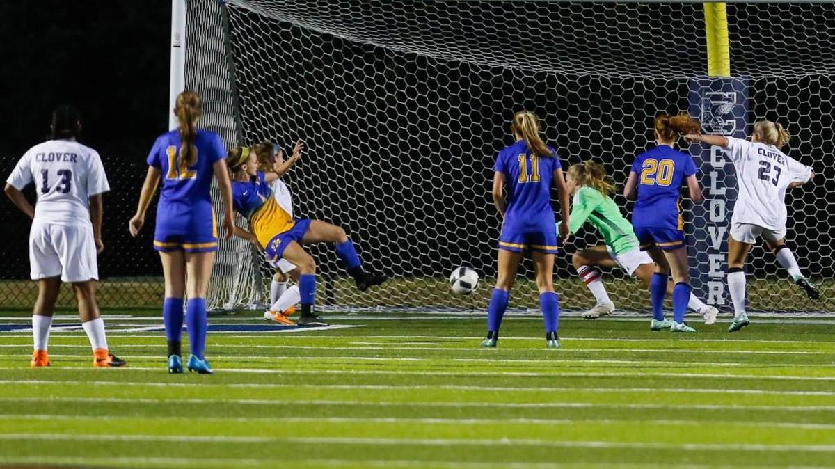 Fort Mill's Erin Wolfe scores to put the Yellow Jackets on the scoreboard as Clover hosts Fort Mill in girls varsity soccer Tuesday, 4-12-2016.