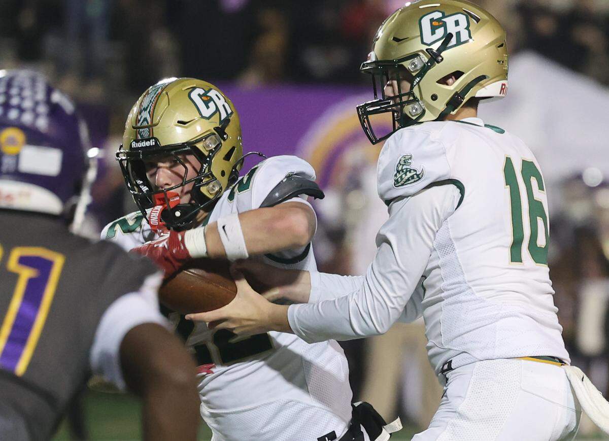 Catawba Ridge High School's Joshua Dobson hands the ball to Casey Fikis Friday, Nov. 14, 2025 in Rock Hill, S.C.
