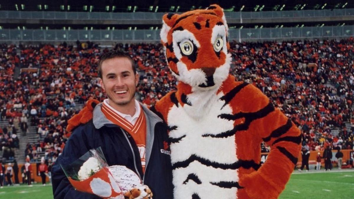 Brett Ringer with the Clemson Tiger mascot on Senior Day in 1998. Ringer passed away in 2001 but a scholarship program in his memory has raised over $100,000 in the 16 years since.