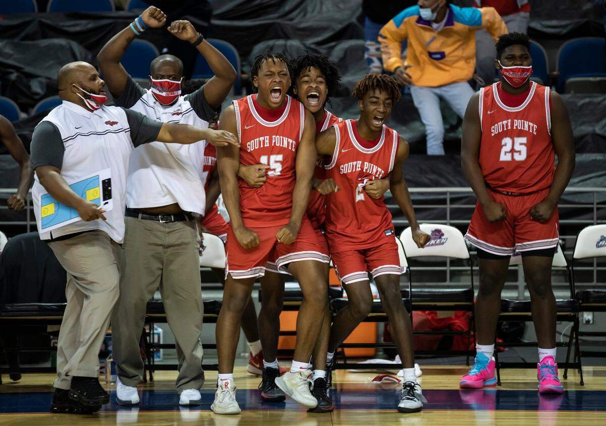 Members of the South Pointe High School basketball team react after going up by two points with 4 seconds left in the the SCHSL Class AAAA state final game between South Pointe and Hilton Head high schools held Saturday, March 6, 2021 at the USC Aiken Convocation Center. South Pointe went on to win, 52-20.