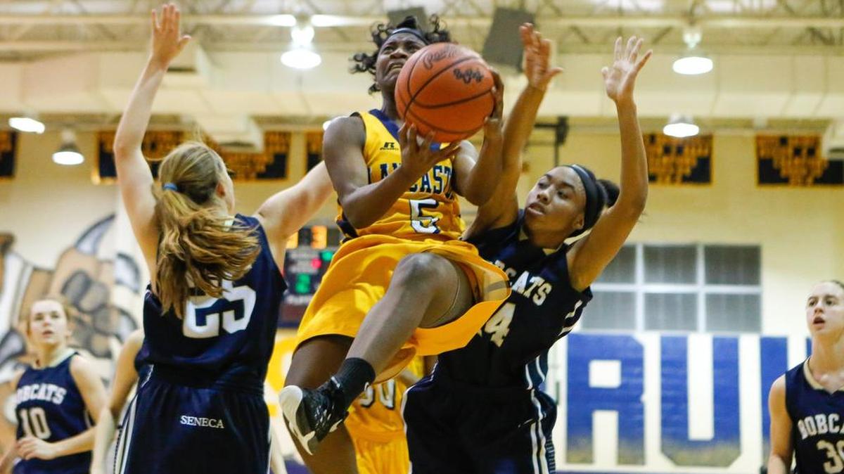 Lancaster’s Shyniya Winfield fights to put up a shot against Seneca in a girls’ AAA playoff game Tuesday .