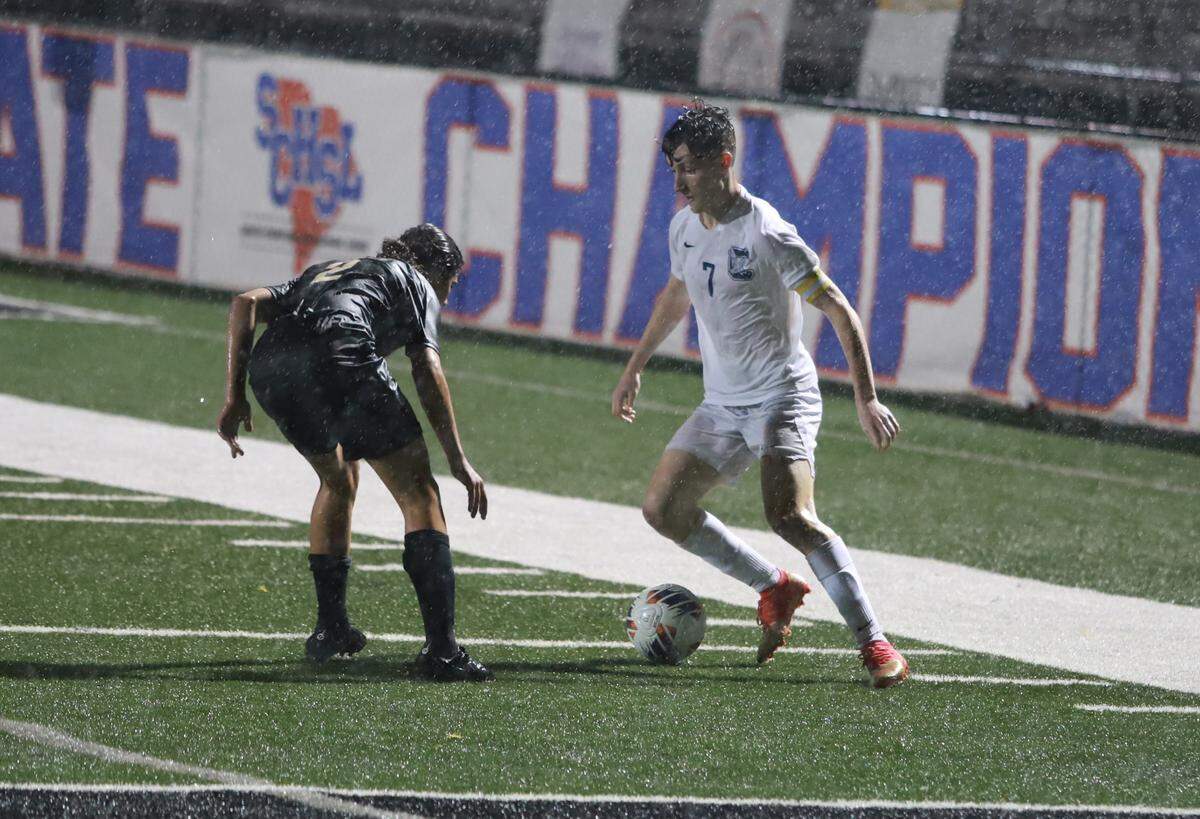 Clover winger Gavin Egan takes on Ashley Ridge defender Alex Benner in the first half of the Blue Eagles’ 2-0 loss to the Swamp Foxes.