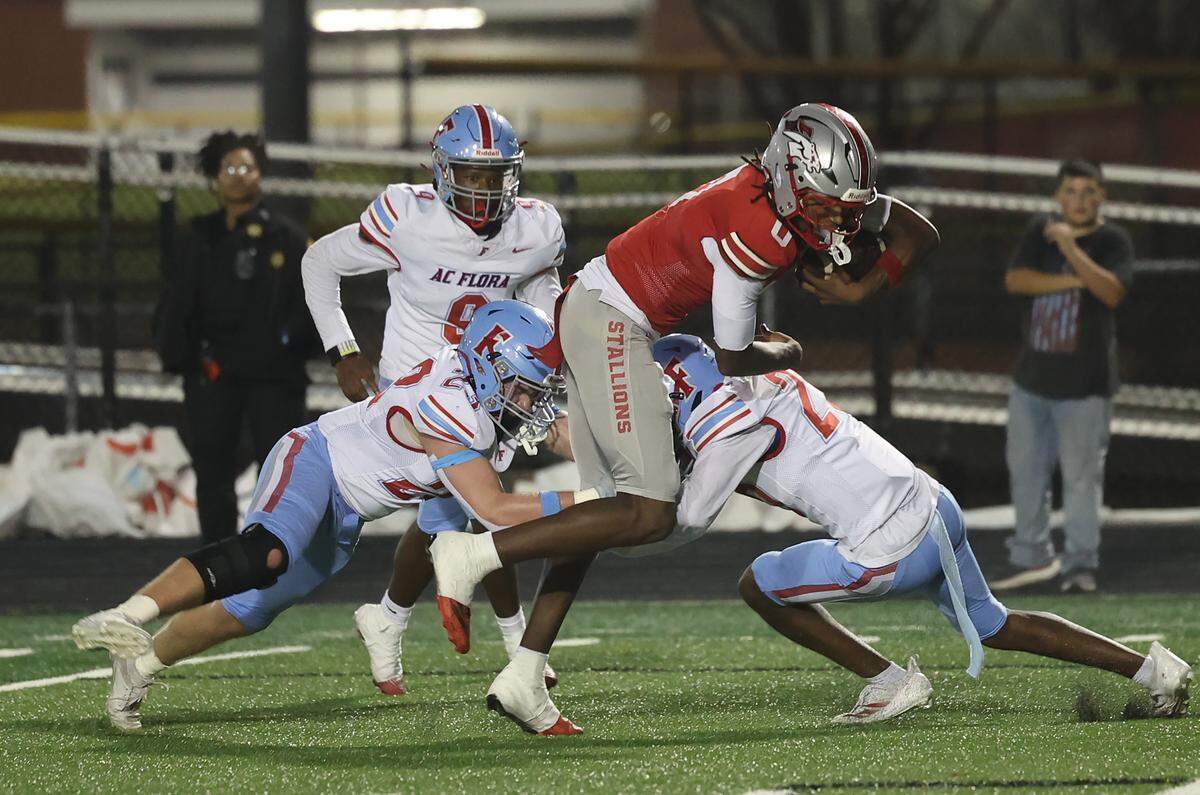 South Pointe's J'zavien Currence is tackled by A.C. Flora defense Friday, Nov. 21, 2025 in Rock Hill, S.C.