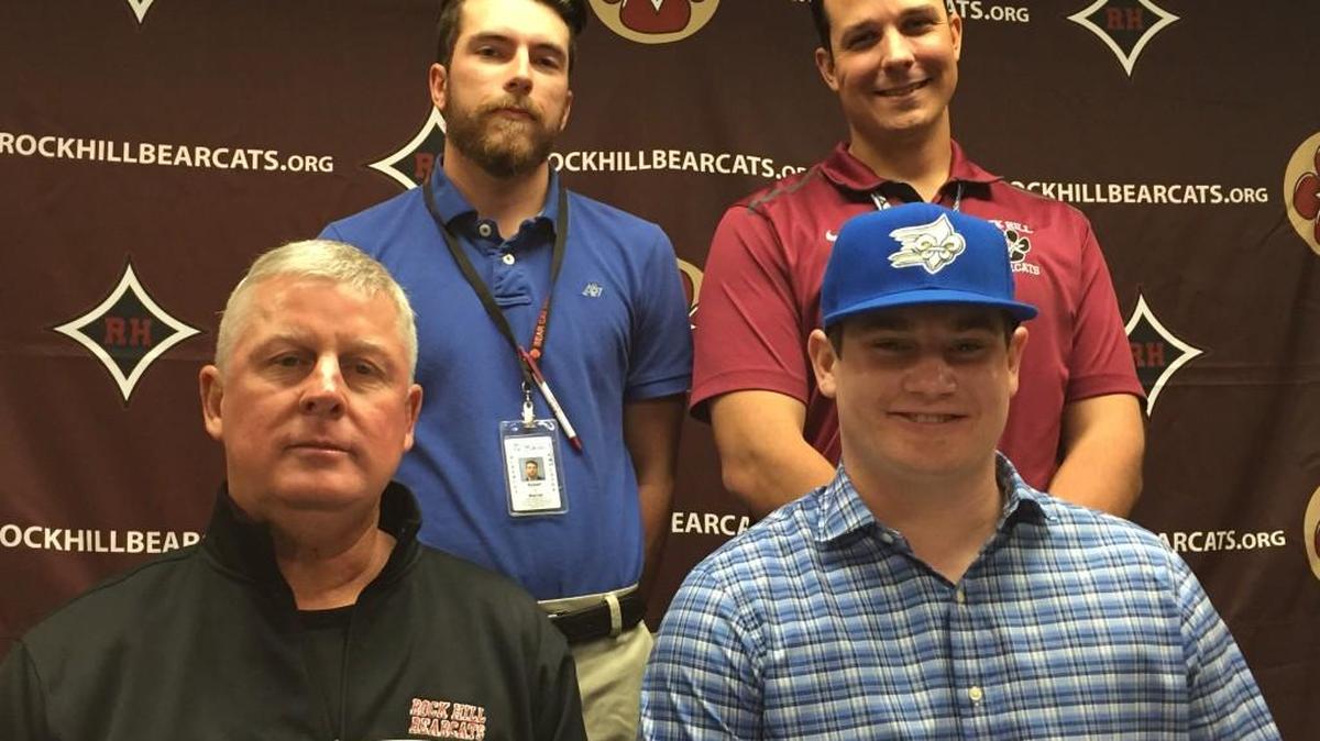 Brandon Banks (front right) signed to play college baseball with Limestone on Wednesday. He was joined by family, teammates and his coaches (clockwise from Banks), Dell Corley, Patrick Elias and Luke Warner.