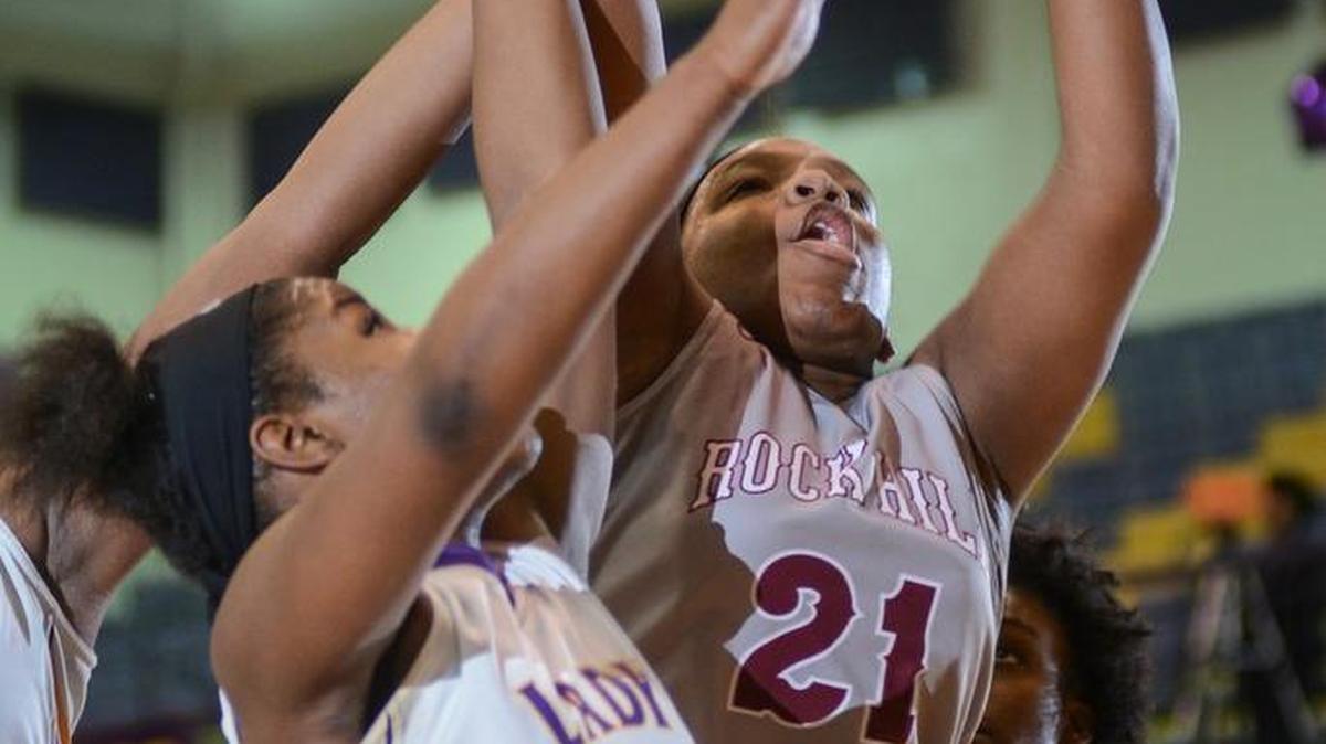 RiKoya Anderson (21) of Rock Hill battles with Northwestern's Nana Jones (3) for a rebound during first quarter action at Northwestern.