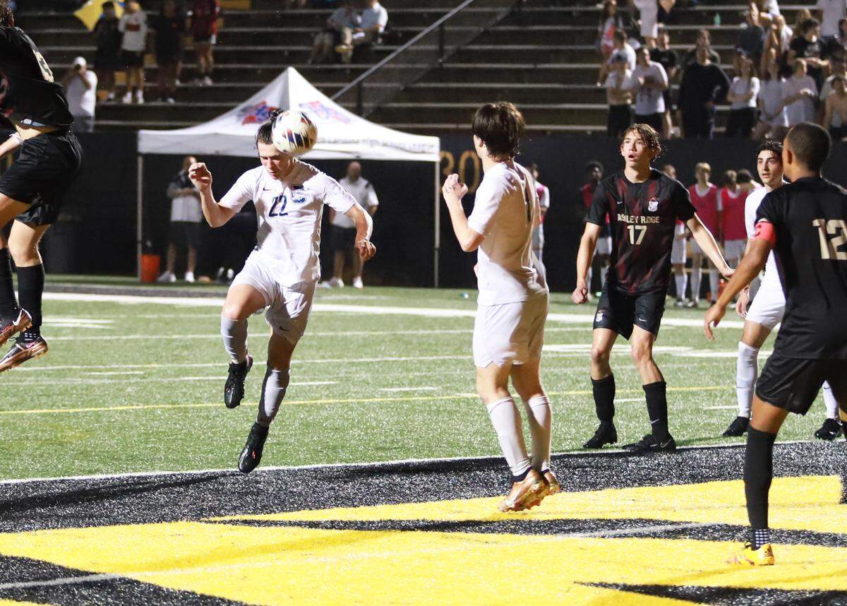 Clover defender Blake Harrill attempts a header in the box in the second half of a 2-0 defeat to Ashley Ridge.