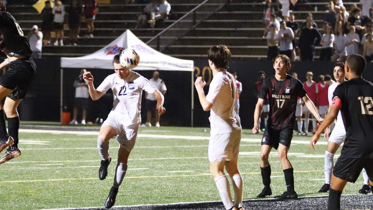 Clover defender Blake Harrill attempts a header in the box in the second half of a 2-0 defeat to Ashley Ridge.