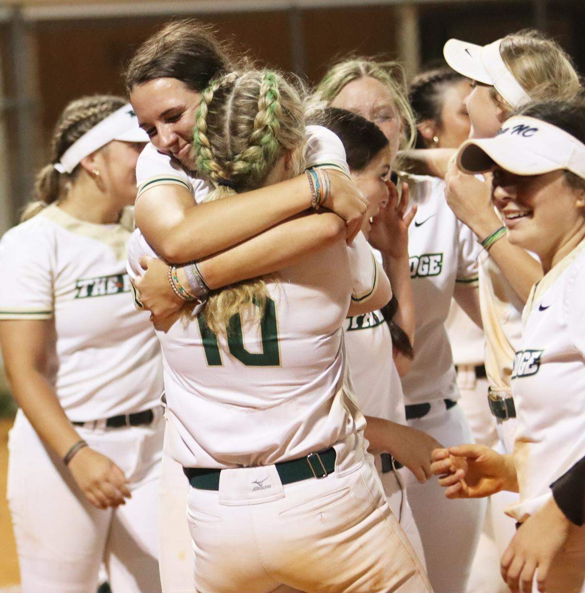 Jenna Gardner (10) hugs her teammate in celebration of Catawba Ridge’s 10-7 win over South Florence to clinch its first ever softball state title.