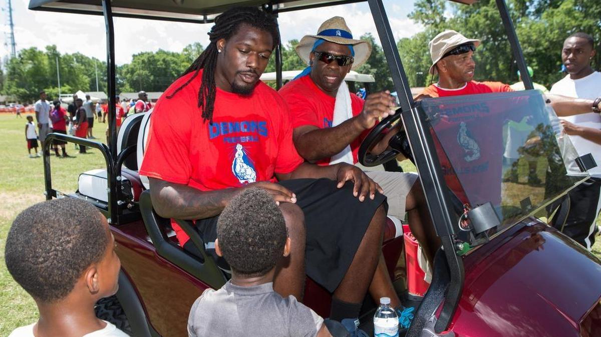 Jadeveon Clowney talks with neighborhood kids before the Sylvia Circle Demons retired his jersey during a June 2015 ceremony.