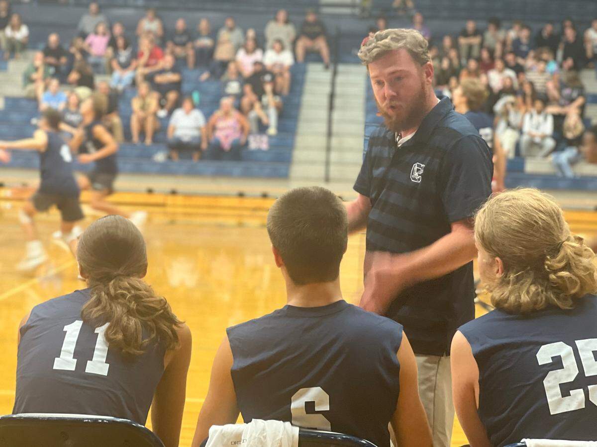 Clover boys volleyball head coach William Plyler talks to his players during the second set of the JV squad’s match against Dorman. Dorman swept Clover in the JV match 25-20, 25-20.