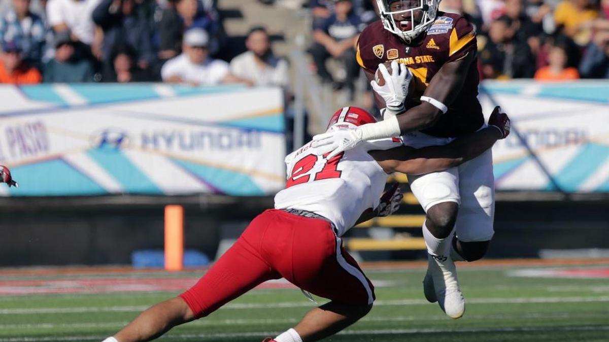 Arizona State running back Eno Benjamin, right, tries to avoid North Carolina State's Nick McCloud in the first half of the Sun Bowl NCAA college football game in El Paso, Texas, Friday, Dec. 29, 2017.