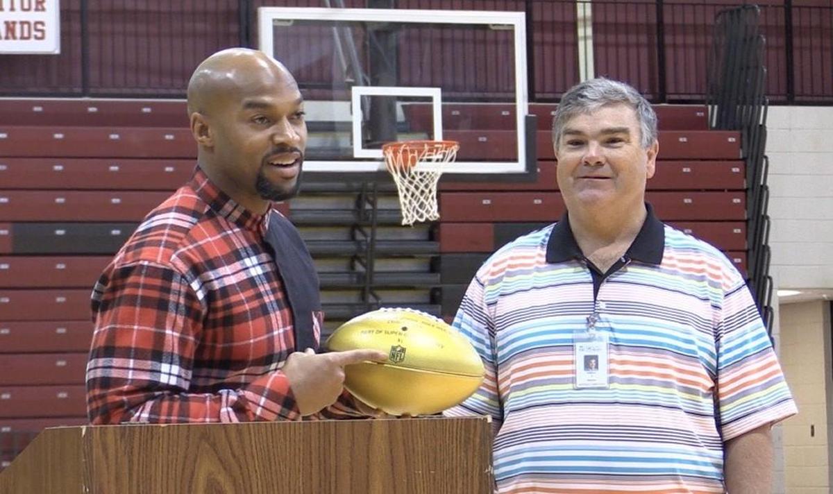 Rock Hill High’s Chris Hope received a golden football from the NFL for playing in a Super Bowl.