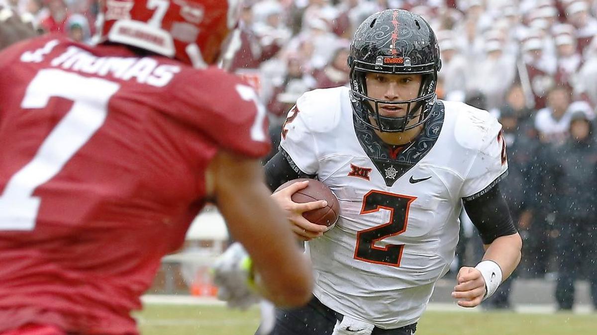 Oklahoma State quarterback Mason Rudolph (2) eyes Oklahoma cornerback Jordan Thomas (7) during a play in the first half of an NCAA college football game, Saturday, Dec. 3, 2016, in Norman, Okla.
