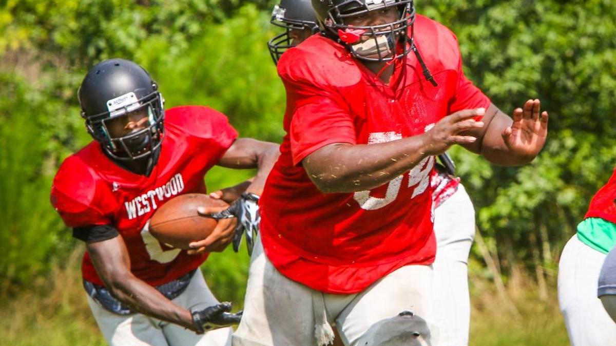 Westwood High football team practiced Monday morning preparing for the season The Red Hawks offensive line averages 315 pounds -- and features five seniors -- all returning starters. Stand-out lineman Torrey Boone blocks for his running back during drills back in August.