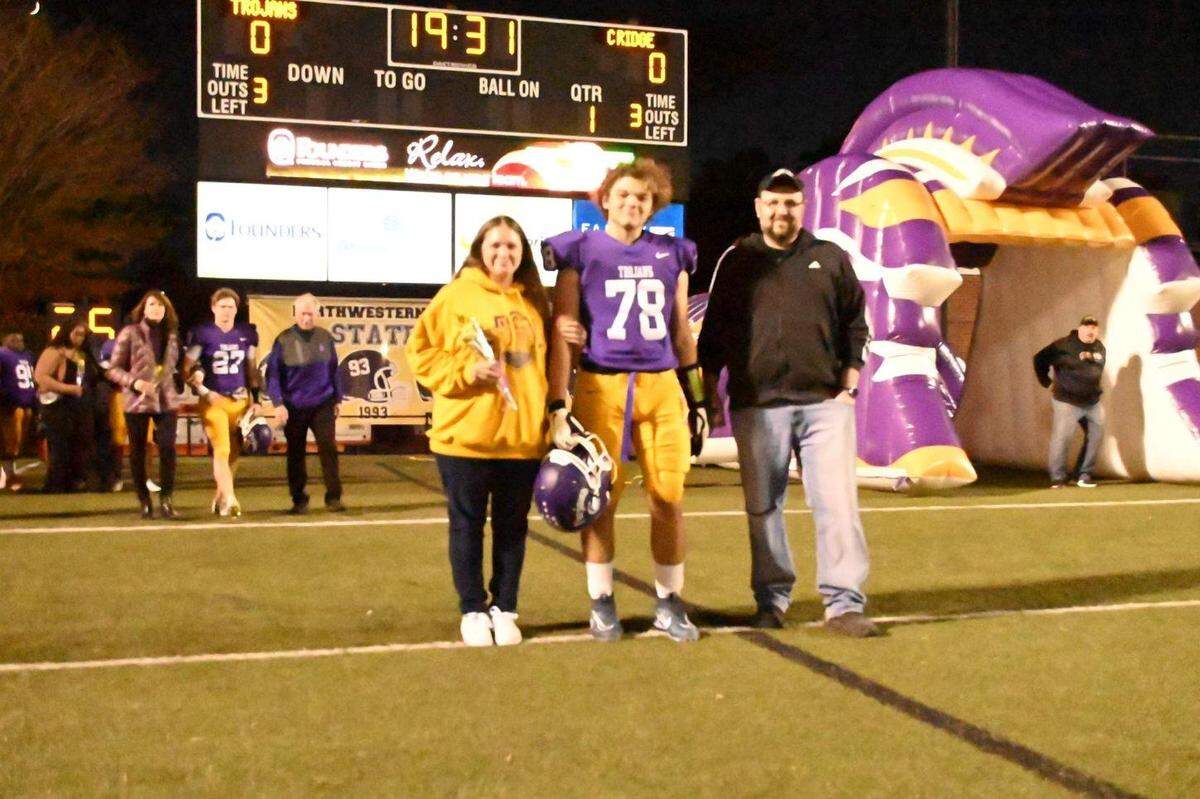 Rizzo walks with his family during Northwestern’s fall senior night.