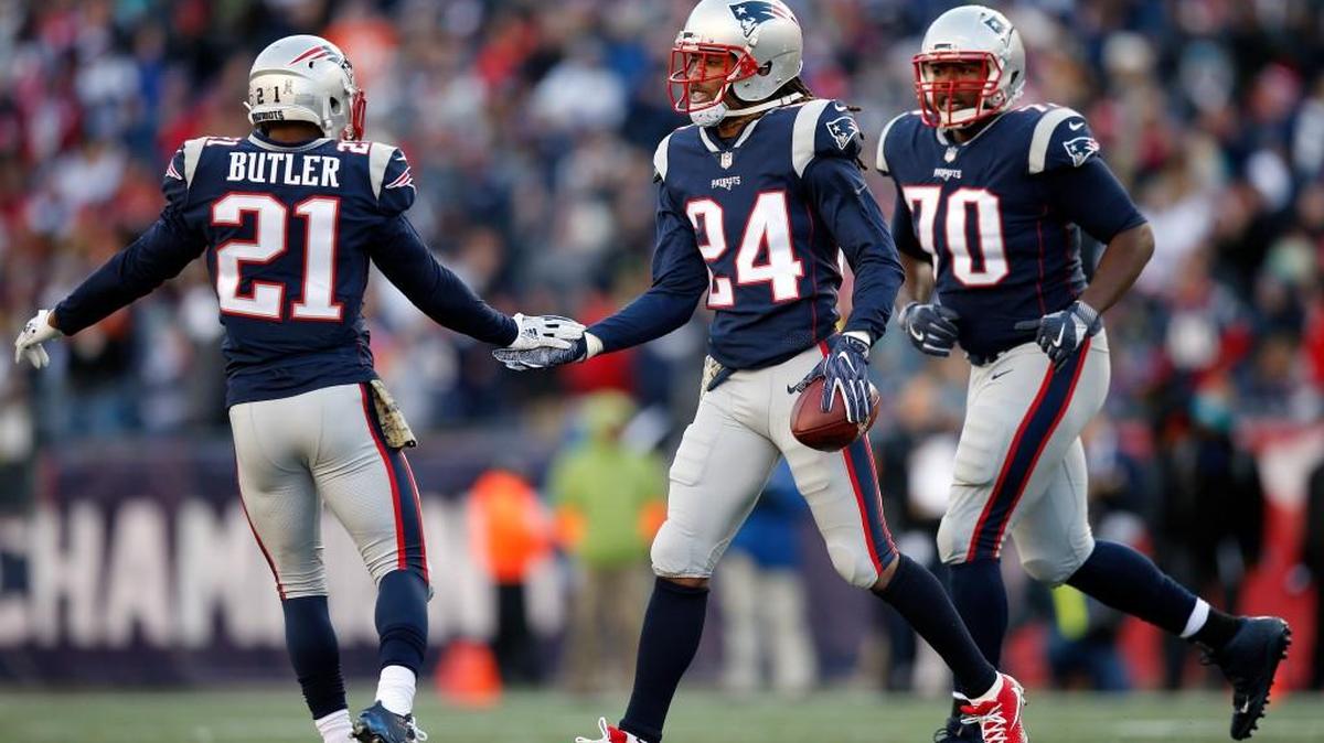 New England Patriots cornerback Stephon Gilmore (24) is congratulated by New Malcolm Butler (21) after he intercepted a pass in the end zone against the Miami Dolphins during the first half of an NFL football game, Sunday, Nov. 26, 2017, in Foxborough, Mass.