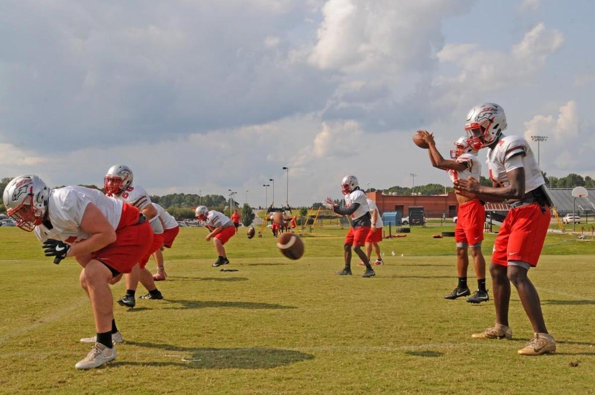 “We’ve only had two bad snaps in four years,” says South Pointe offensive coordinator Jason McManus, as the team’s four centers and QBs work on that very skill.