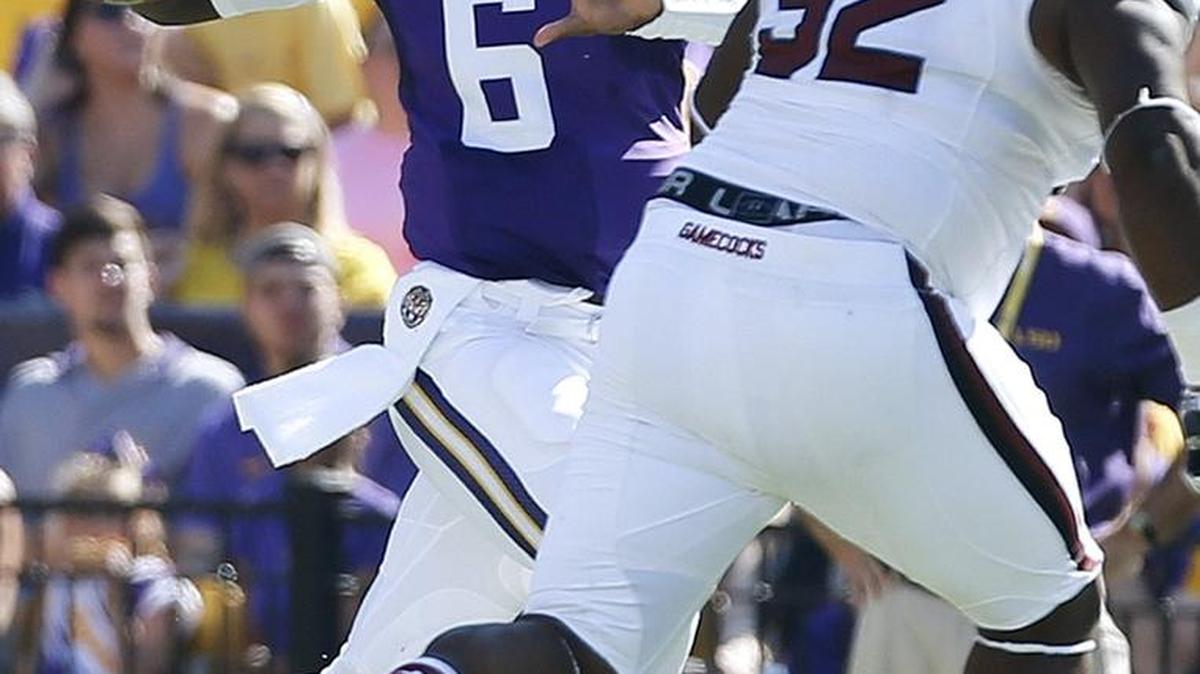 
LSU quarterback Brandon Harris (6) throws the ball past South Carolina defensive tackle Gerald Dixon Jr. (92) during the first half of an NCAA college football game in Baton Rouge, La., Saturday, Oct. 10, 2015. LSU won 45-24. 
