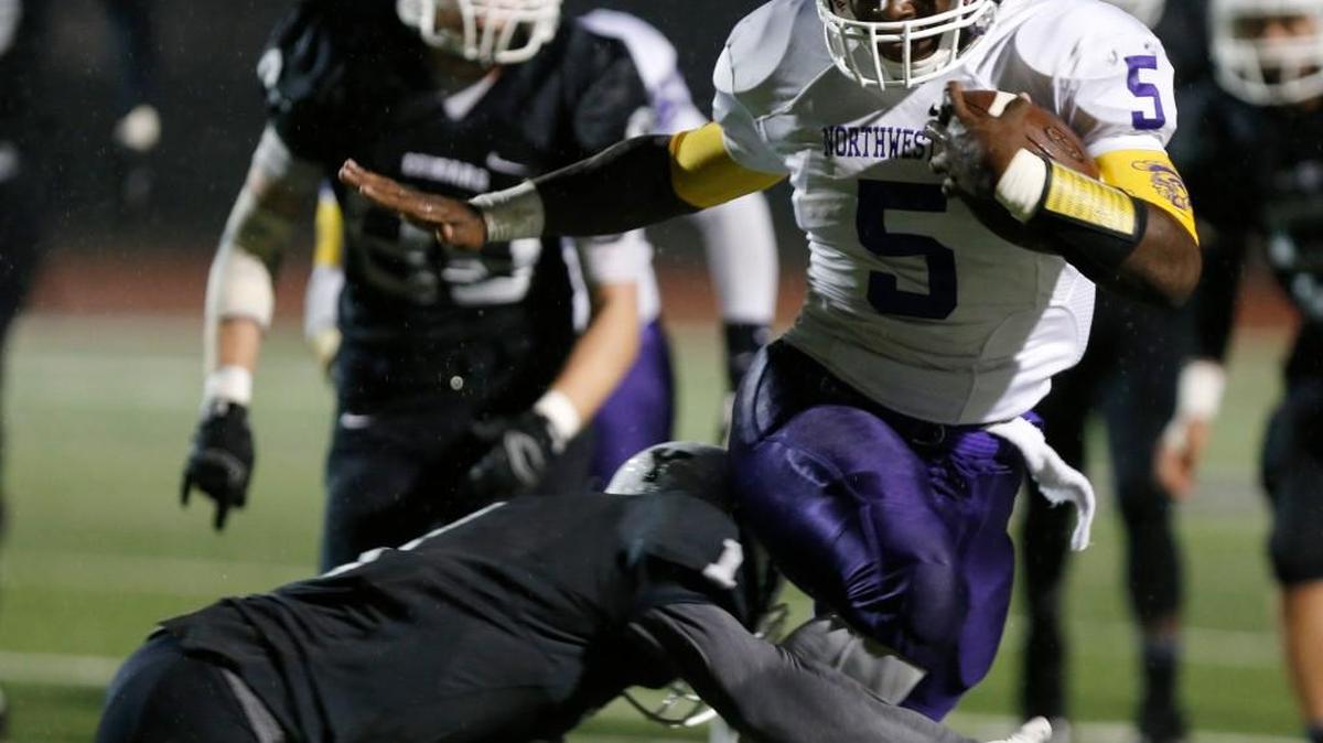
Northwestern’s Jerry Howard (5) is taken down by York’s Javione Matthews (1) in York’s game against Northwestern on Friday.. 
